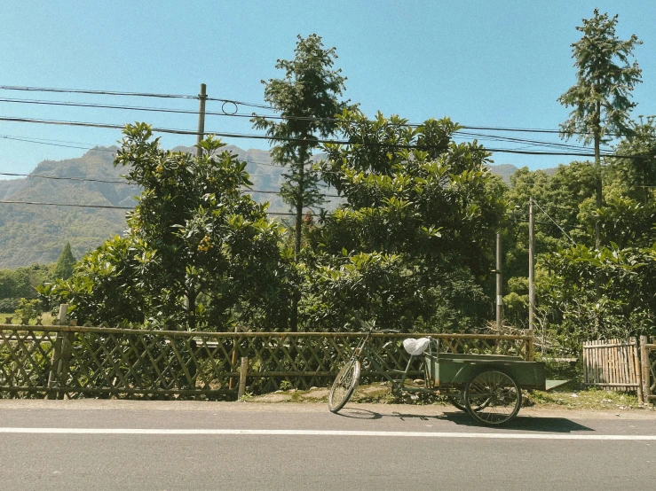 man riding on bicycle down an empty street