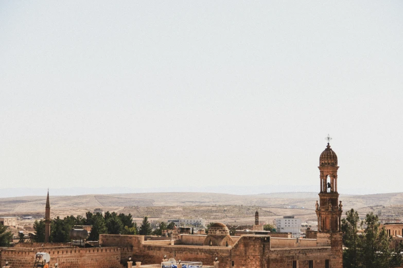 a small tower with many clocks on it stands high above the old city