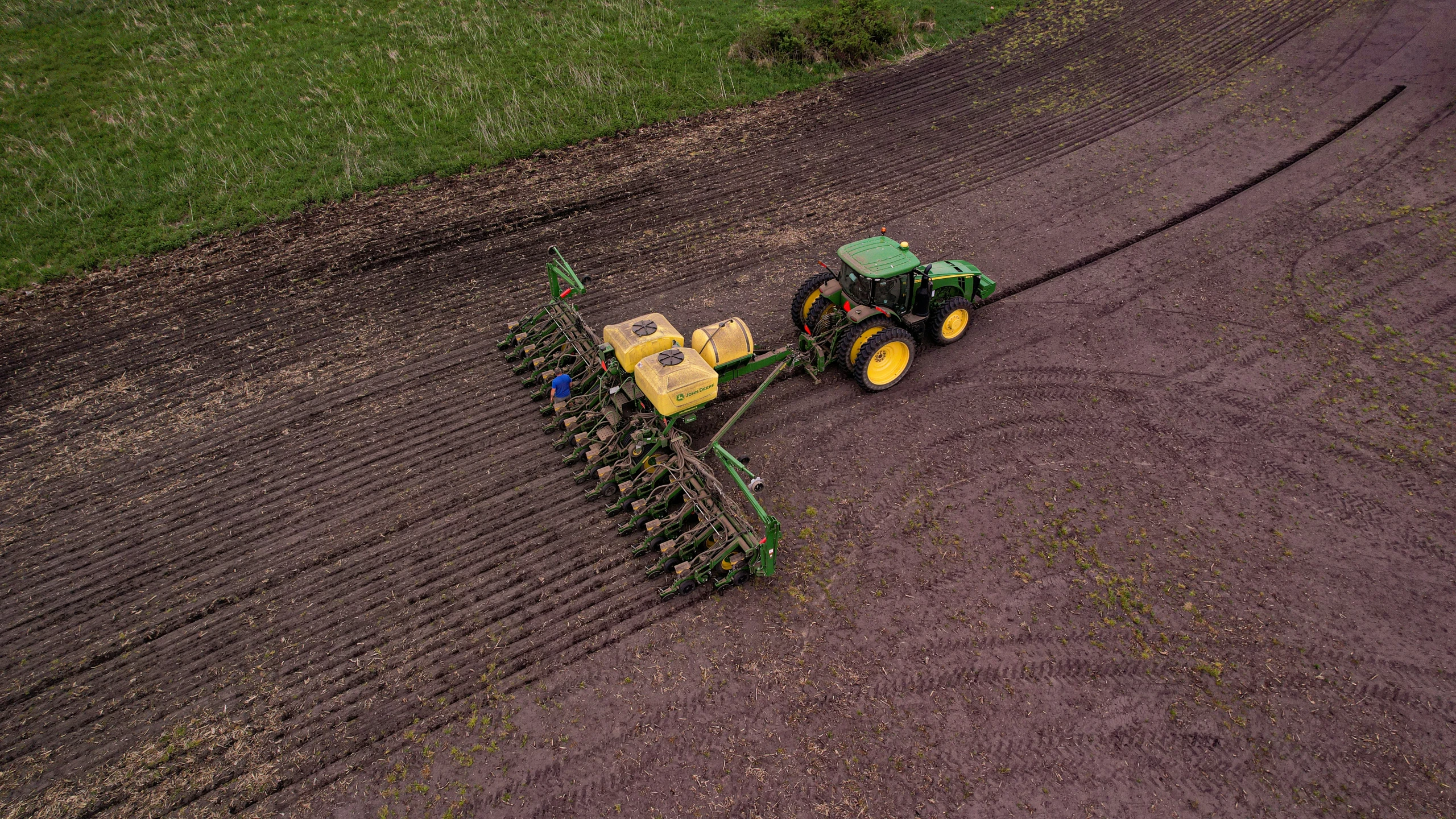 a large tractor plowing an open field