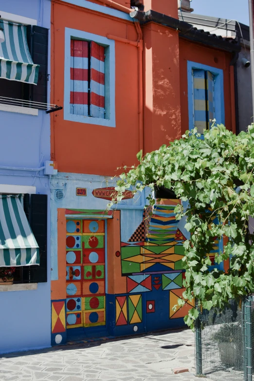 an abstract mural of a colorful building's windows