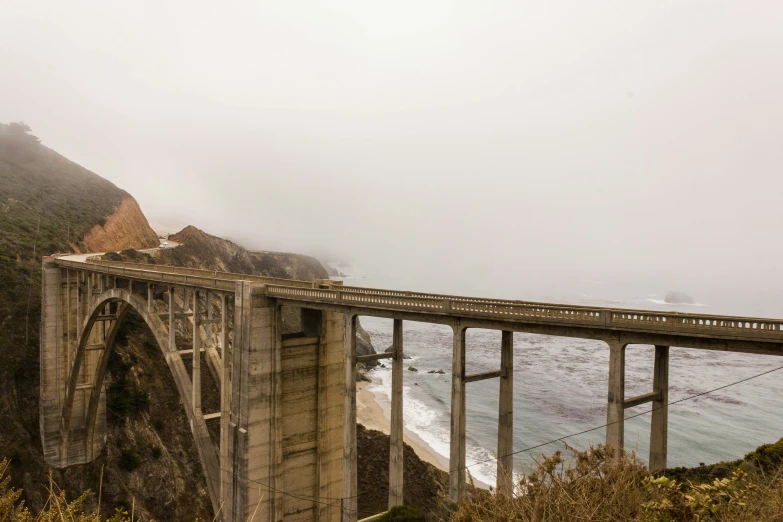 a bridge going over the water that is very rough