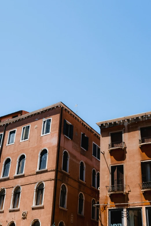 two tall brick buildings with many windows on each building