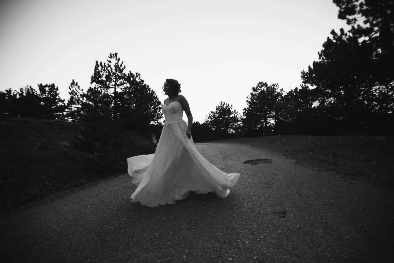 a woman standing on a dirt road