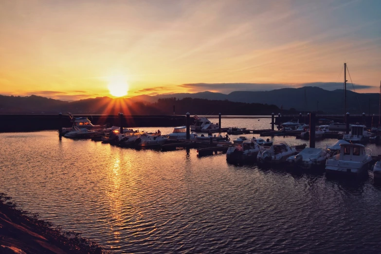 a po of boats at sunset from across the water