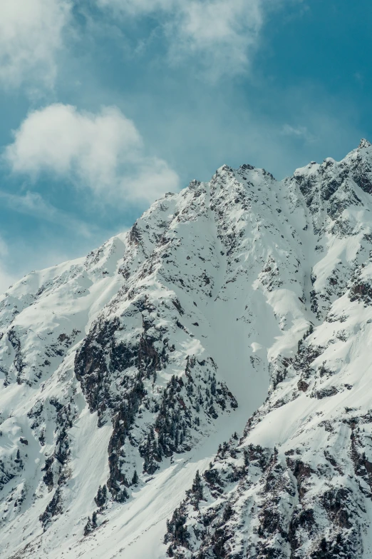 a mountain in the winter with snow covered peaks