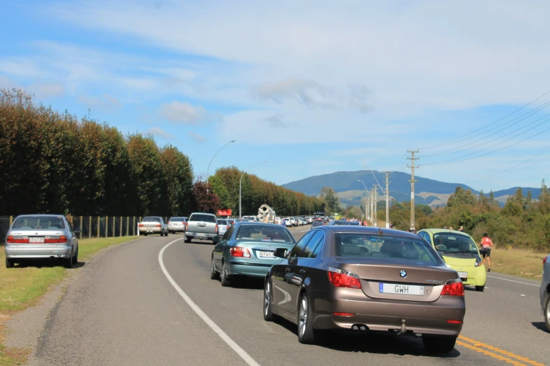 cars are lined up on the road in traffic