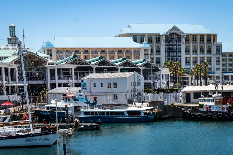 small boats are docked in a marina on a clear day