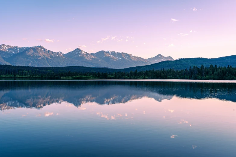 a picture of a lake with some mountains in the background