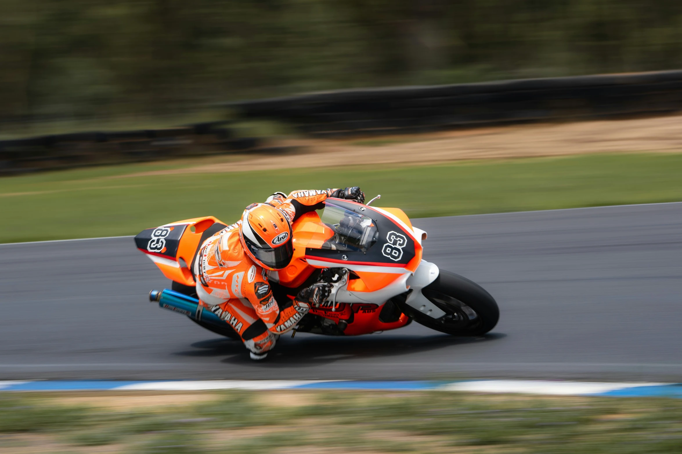 a person riding a motorcycle around a track