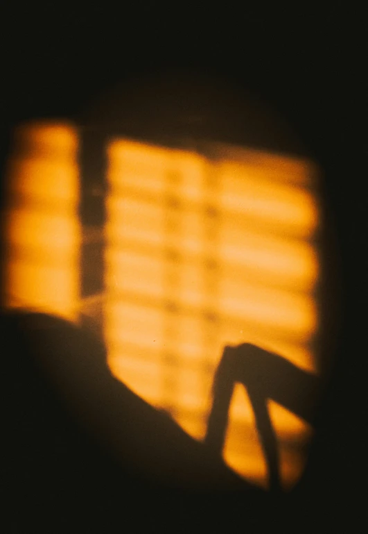 the shadow of a chair in front of a window