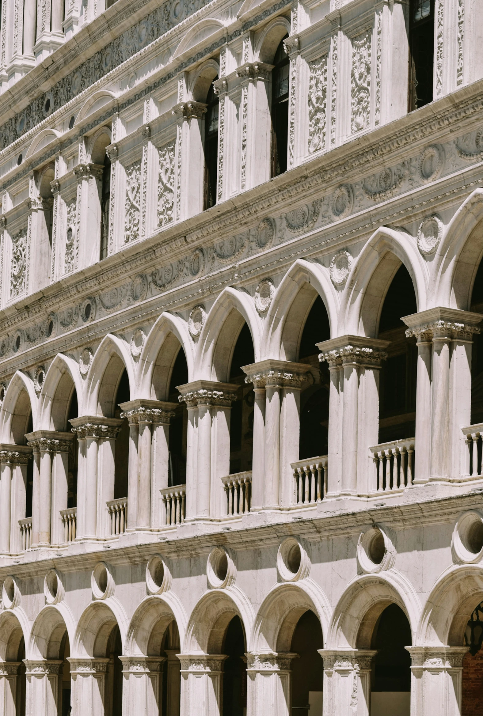 arched stone building with door open in front