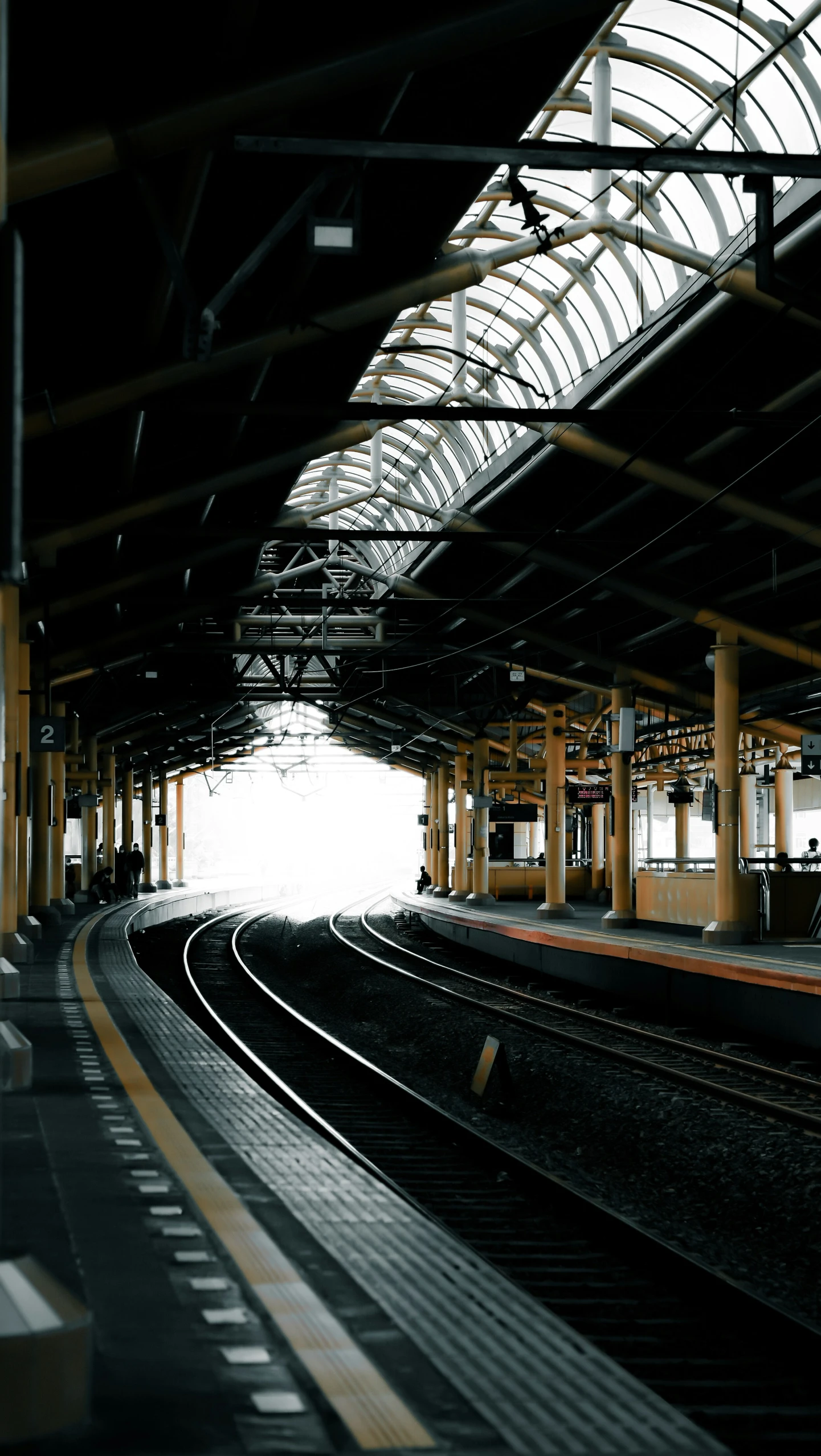 a train station with rails and a train on the tracks