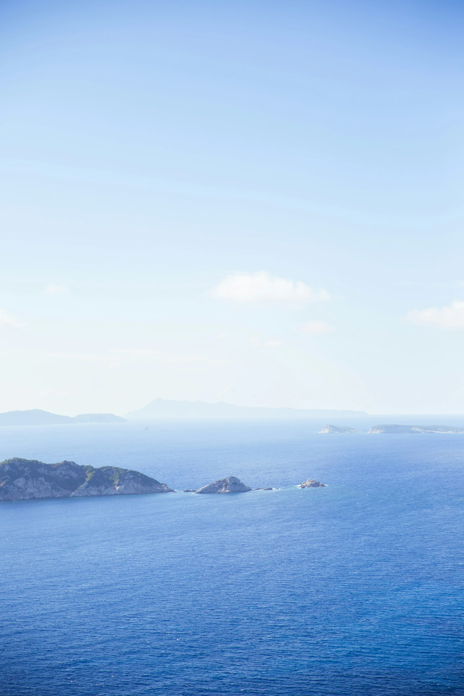 a large body of water with a small island in the middle