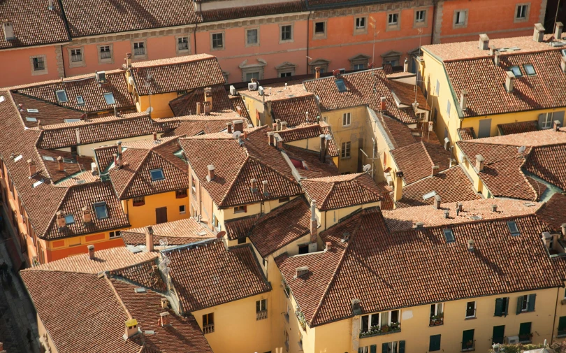 the roofs are tiled in color, and the buildings in the background are tan