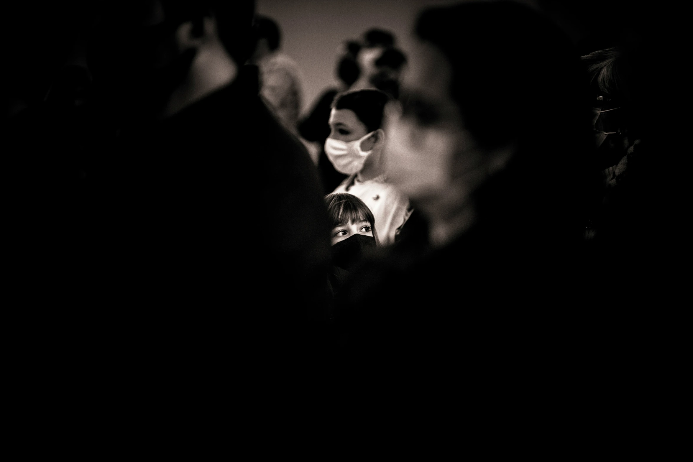 a group of people sitting next to each other in darkroom