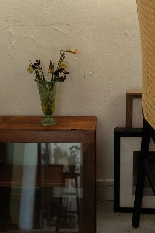 vase full of flowers sits on top of a table