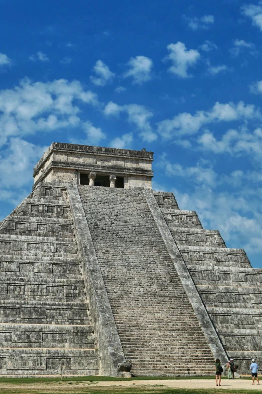 two men walking across a large pyramid made of bricks