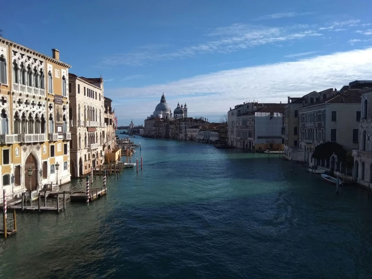 an waterway next to buildings with a clock tower