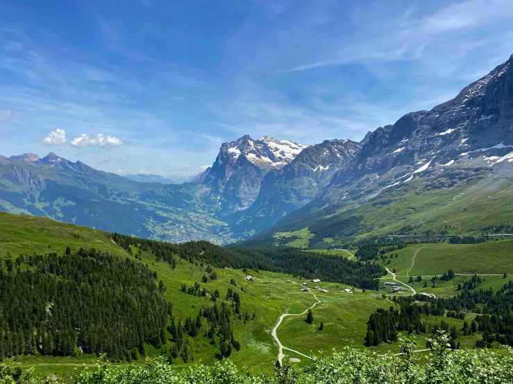 view of a valley, mountains and a highway