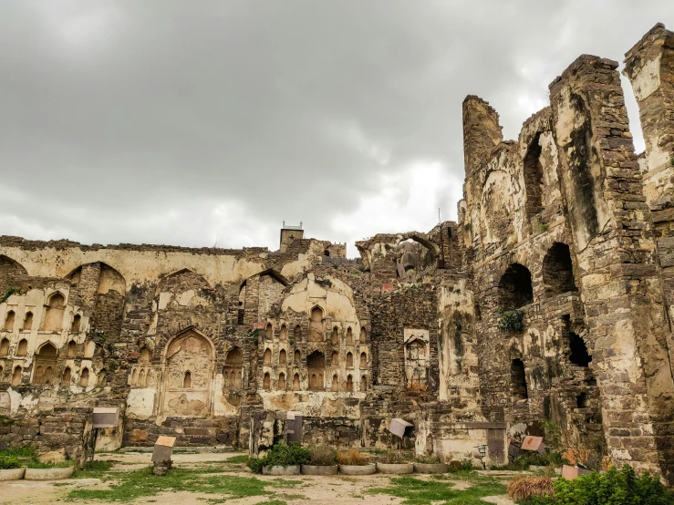 an old ruin with a bunch of windows and ruins on the side