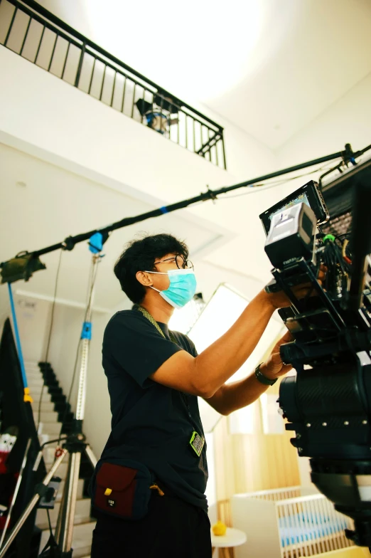 a man wearing a mask is recording in a studio