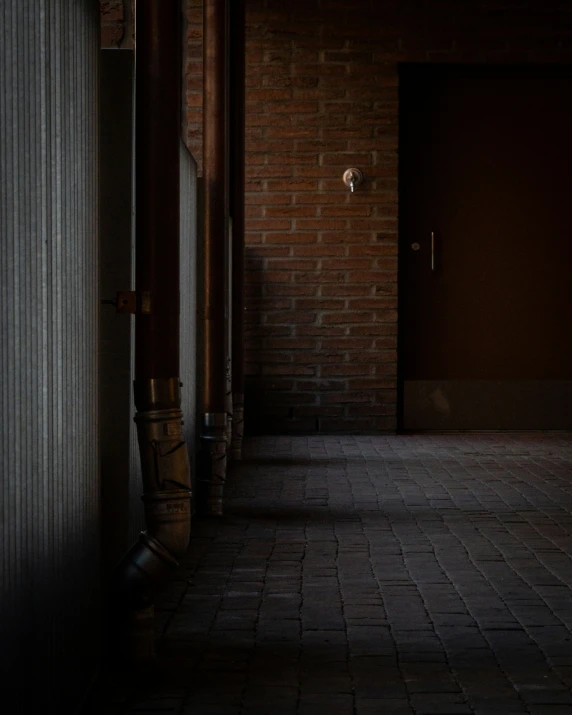 hallway in a house with brick walls, windows and doors