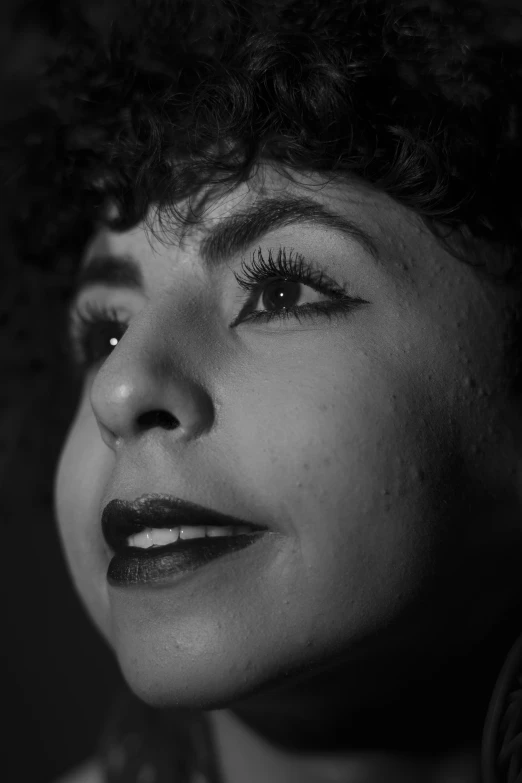 woman with short black hair looking in to the sky