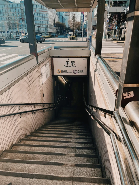 a subway train tunnel with a staircase next to it