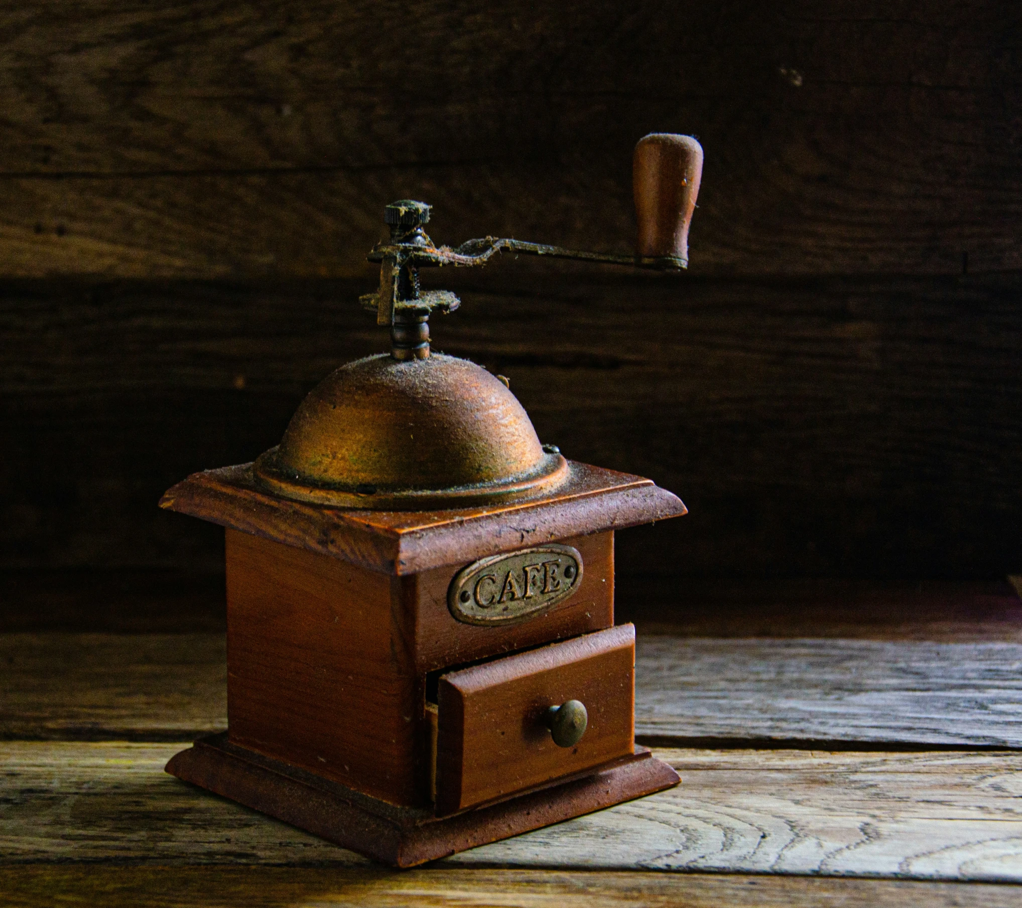 an old, wooden grinder with a metal lid