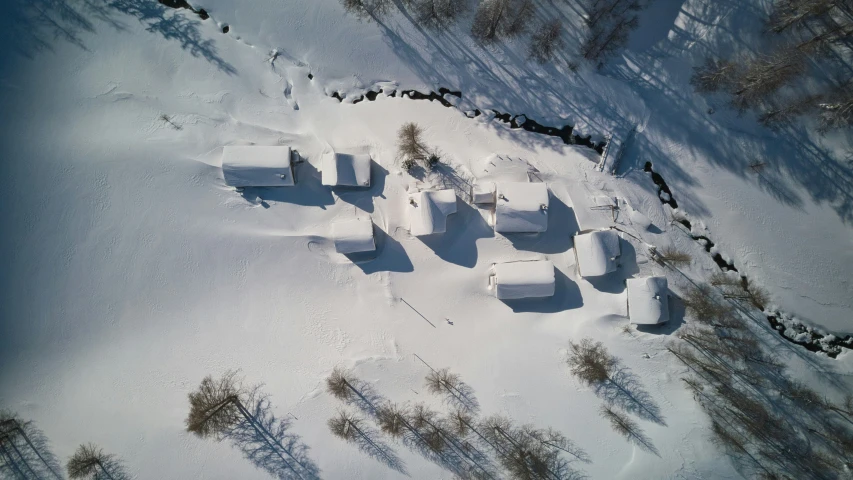 a po taken from a small bird's eye view of some houses in the snow