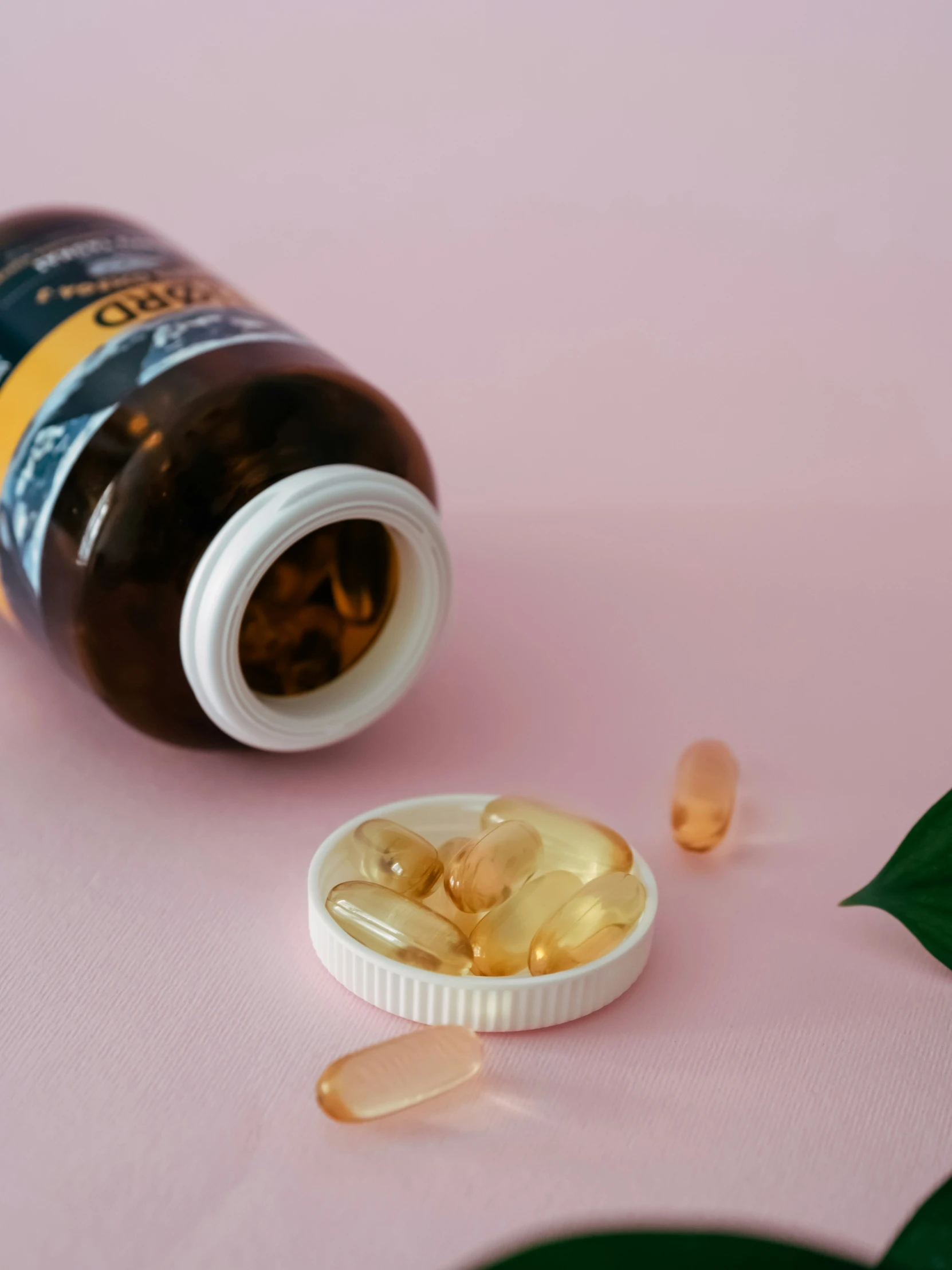 a bottle of vitamins is lying next to a pill holder