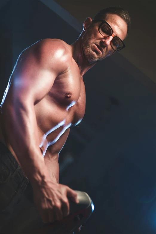 a shirtless man using a skateboard at a night club