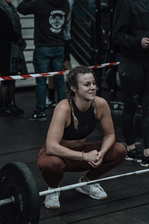 woman squatting down to squat at crossfit