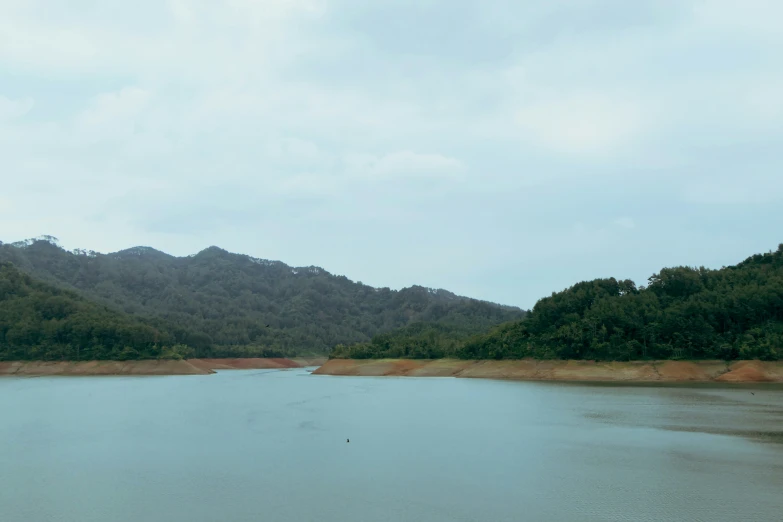 a view of some water and mountains from the shore