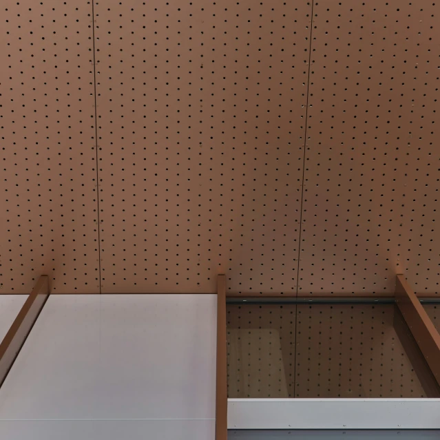 a table sitting in front of a brown wall with dots