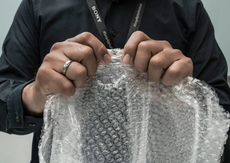 a man holding a plastic bag in both hands