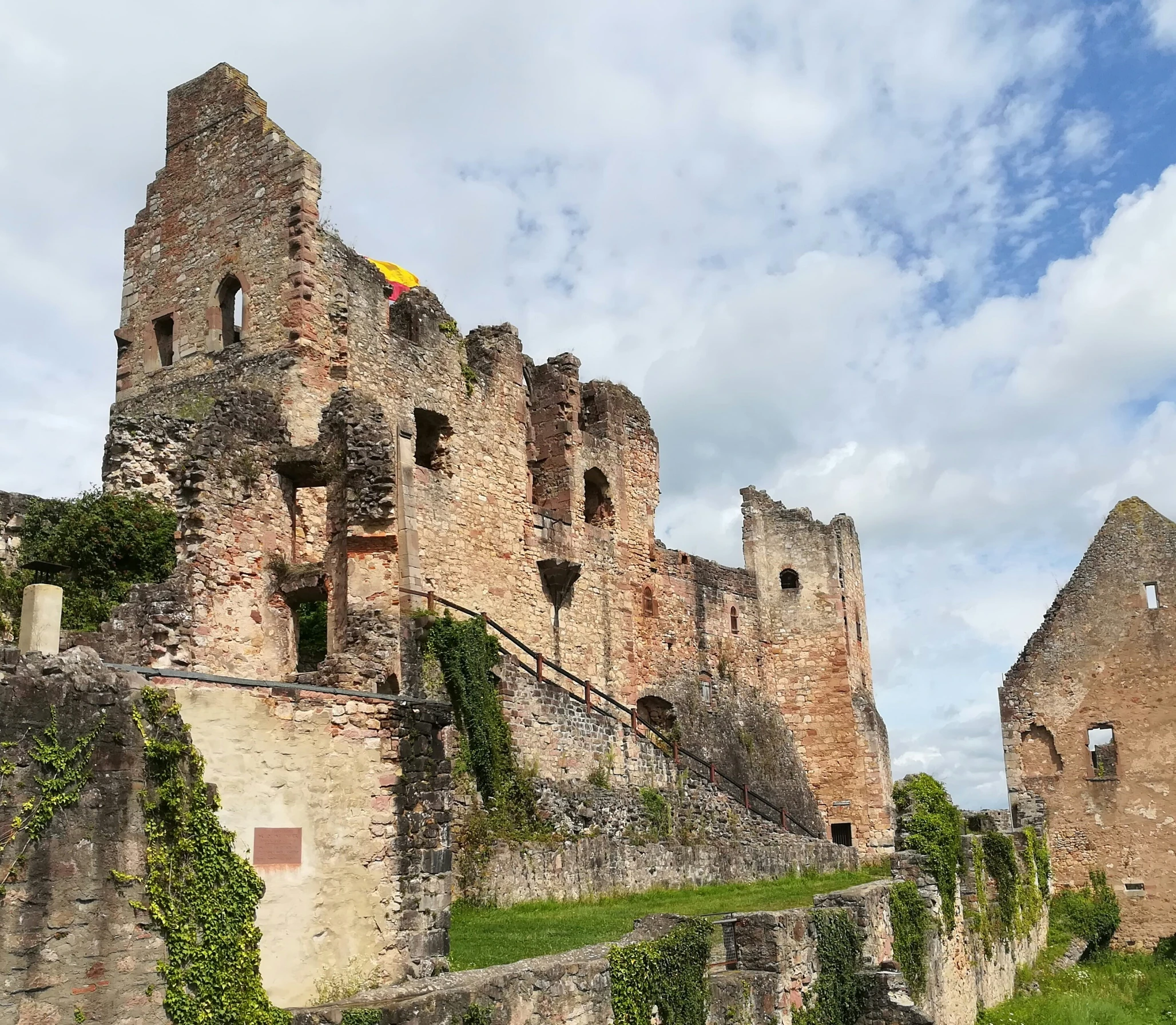 an old castle sits at the top of some steps