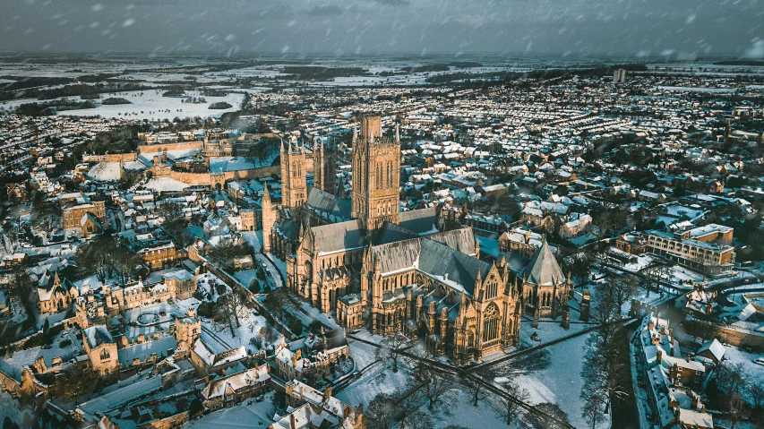 an aerial view of a city with snow falling