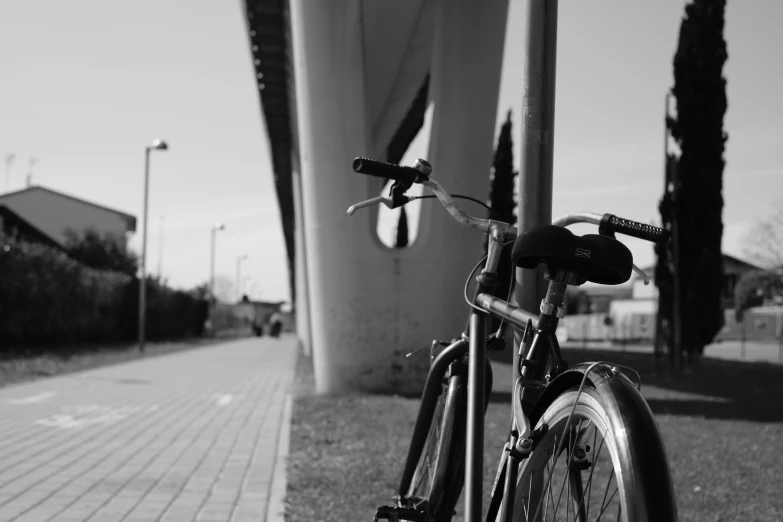 a bicycle parked by a large building with palm trees