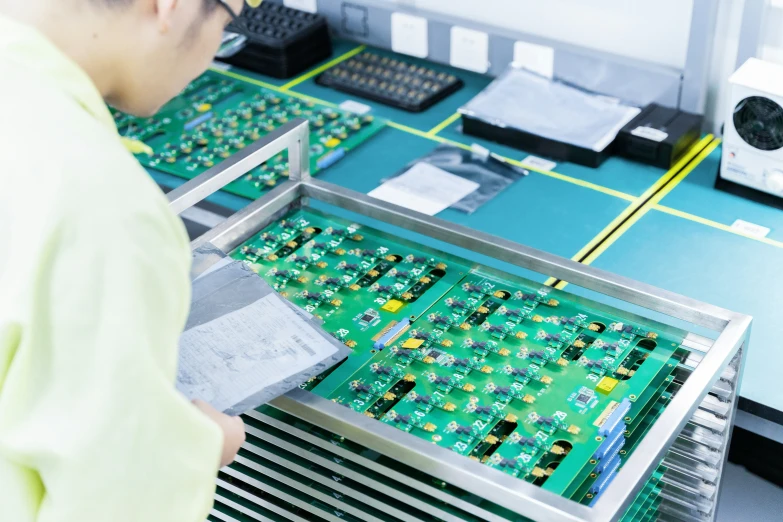 a worker working on computer components in a electronics manufacturing