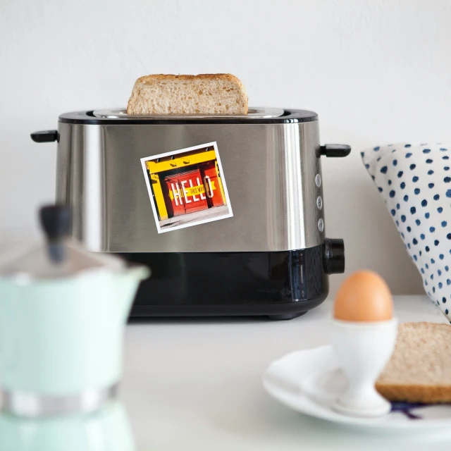 toasters sit next to each other on a white table