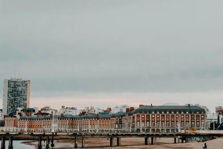 a city is situated at the waterfront with a large building in the background