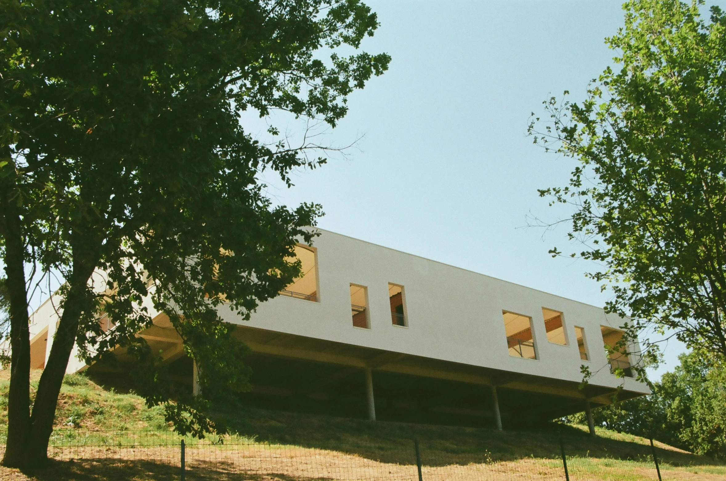 the building is white with three storying windows