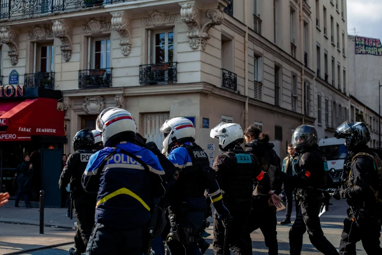 people in riot gear walking down the street