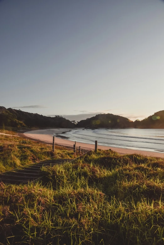 a beach is in the distance near a hill