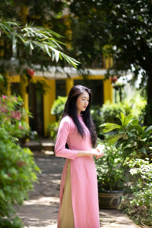 a woman dressed in a pink and brown outfit