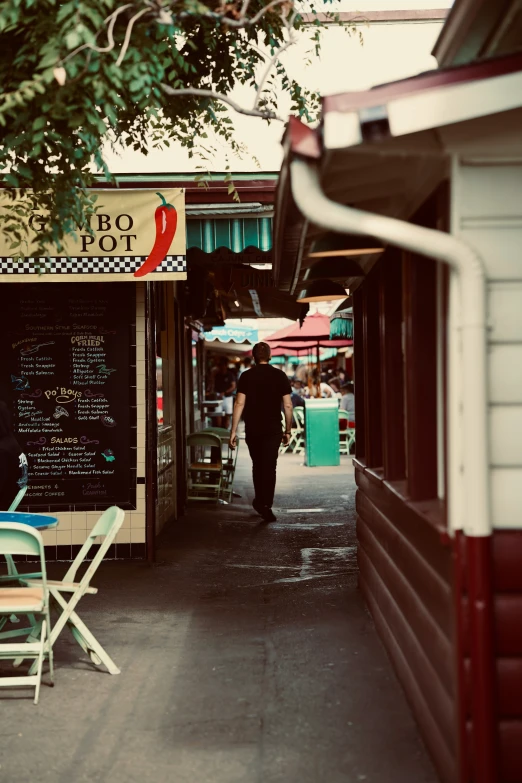 a person walks past the sidewalk of a cafe