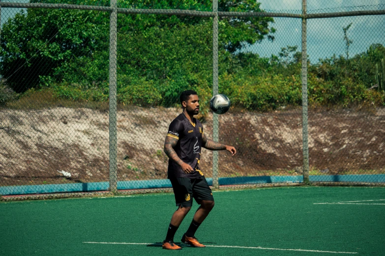 a young man is on an outdoor soccer field with the ball