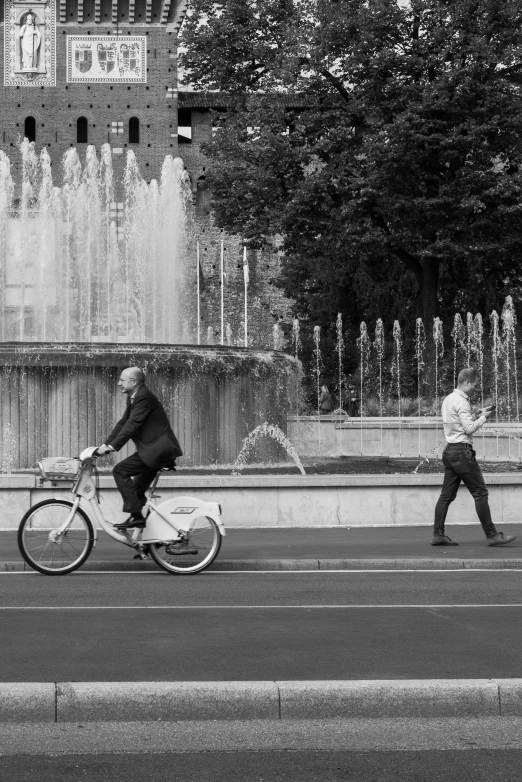 a man on a bike and a little boy running down the street
