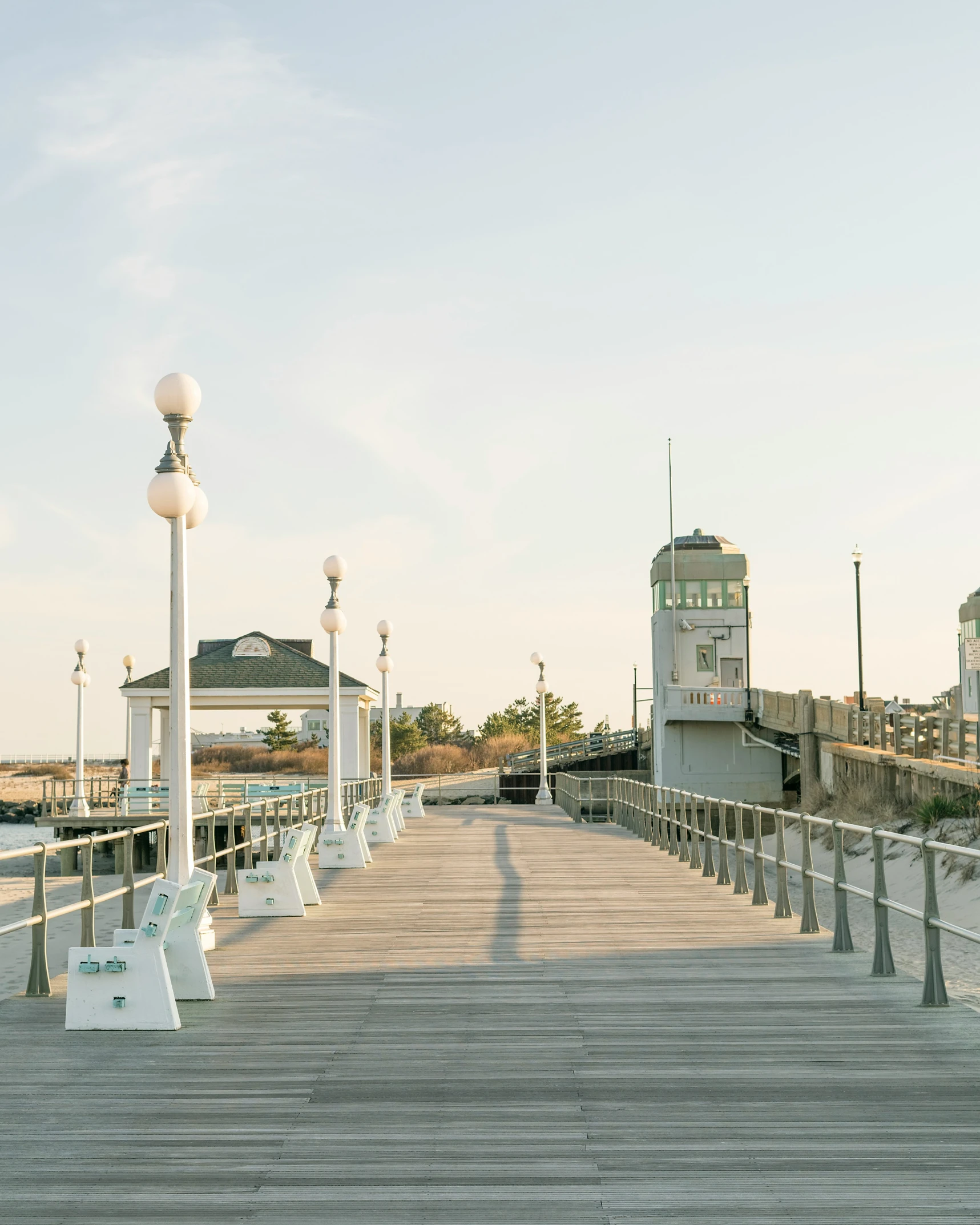 a wooden walkway with some lights on each end